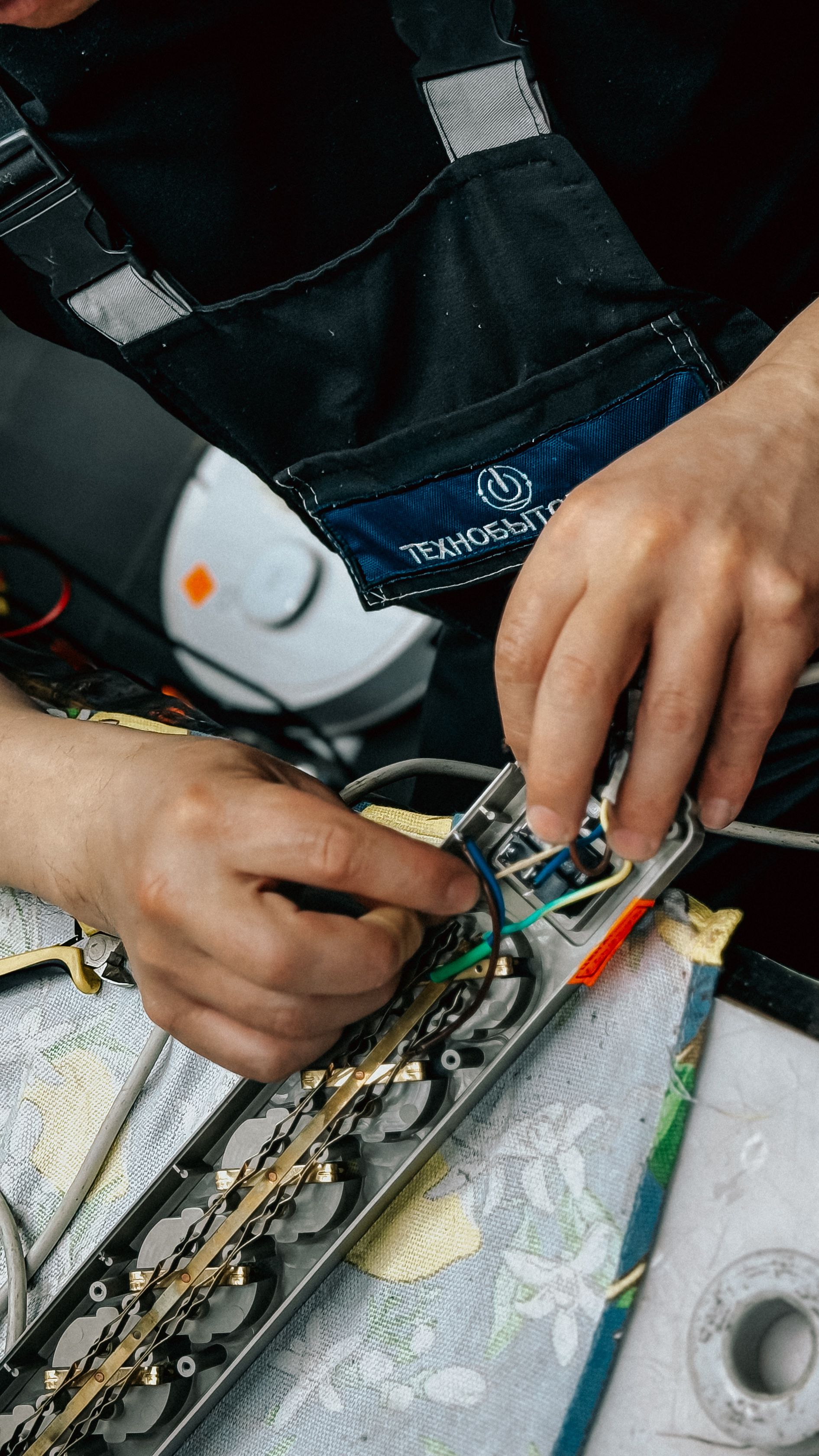 Electrician repairing exposed wiring during an emergency callout